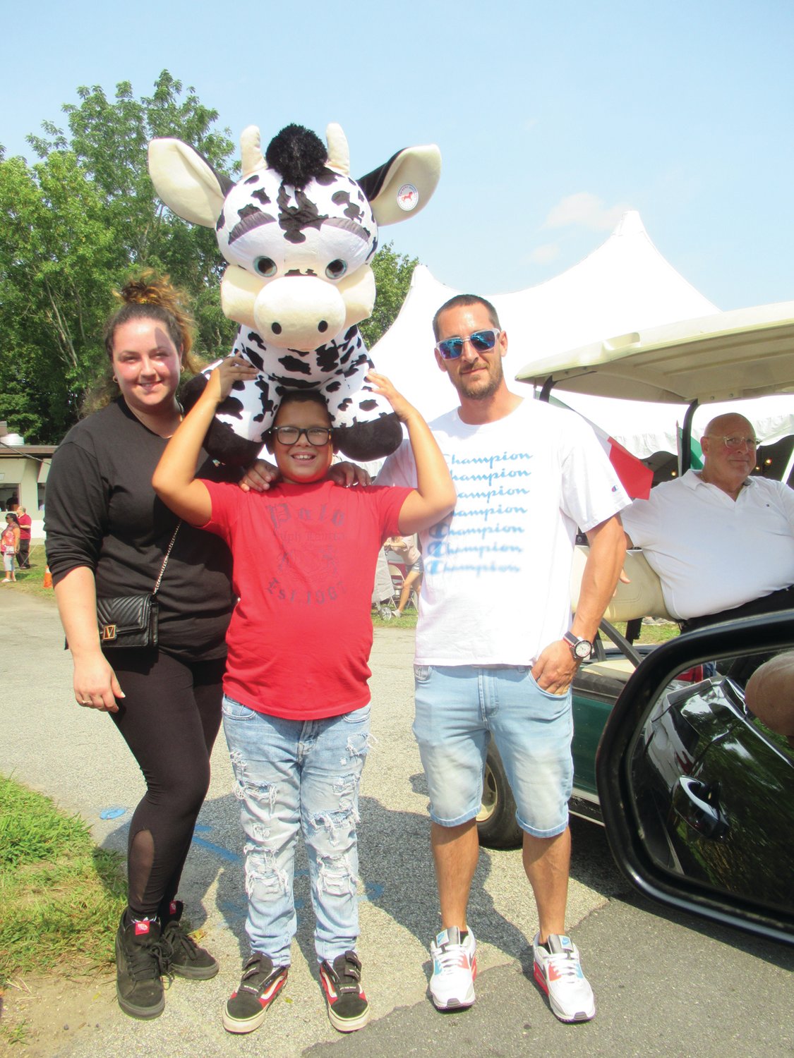 KEVIN’S KOW: Kevin Gorkin is accompanied by Dinna Gorkin and Tyler Archambault and shows off this over-sized stuffed cow he won while playing a Rockwell Amusements game at last weekend’s OLG feast and festival.          